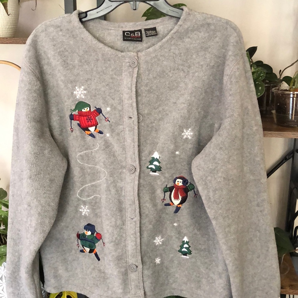 Penguin skiing button up sweater